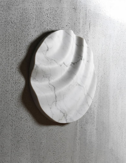 White marble circular wall sculpture with soft carved waves by SquareOff