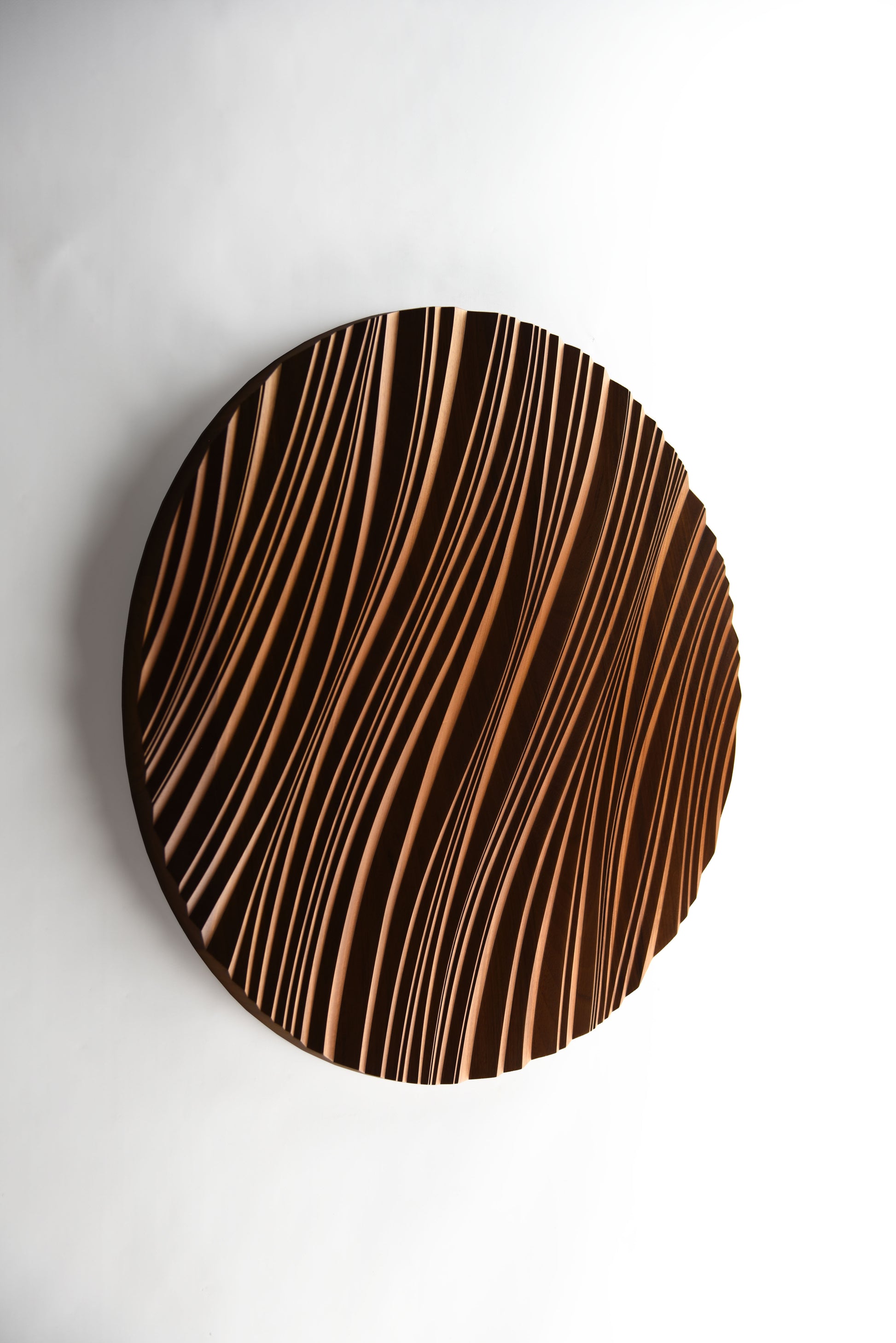 Close focus on swirling erosion ridges in iroko, echoing 3d wall panels style with subtle geometric design in each carved wave.