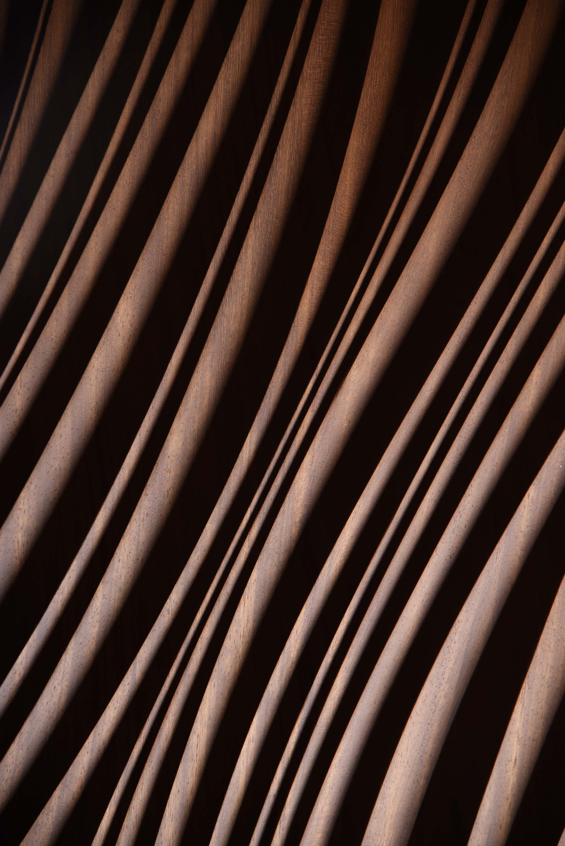 Macro shot of layered erosion texture in iroko, complementing scandi interior aesthetics or boho chic interior warmth in subtle waves.