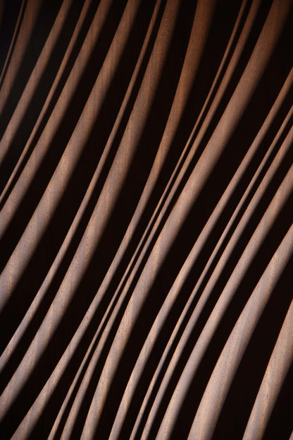 Macro shot of layered erosion texture in iroko, complementing scandi interior aesthetics or boho chic interior warmth in subtle waves.