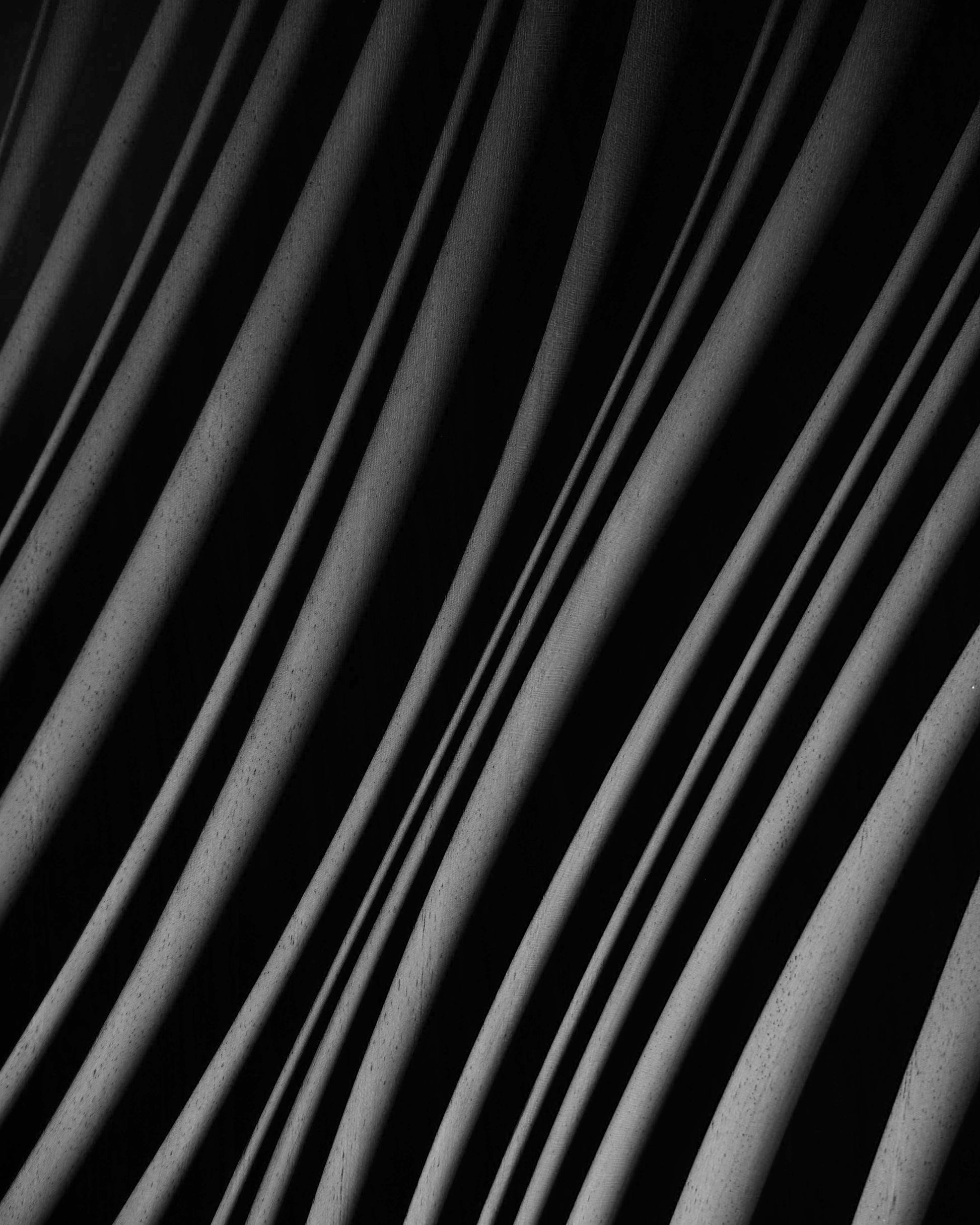 Close focus on swirling erosion ridges in iroko, echoing 3d wall panels style with subtle geometric design in each carved wave.