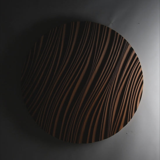 Round iroko ‘erosion’ panel brightening a minimalist dining corner, bridging scandi interior calm and geometry art influences.