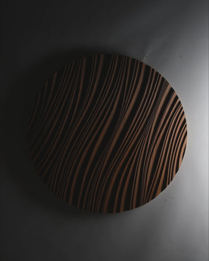 Round iroko ‘erosion’ panel brightening a minimalist dining corner, bridging scandi interior calm and geometry art influences.