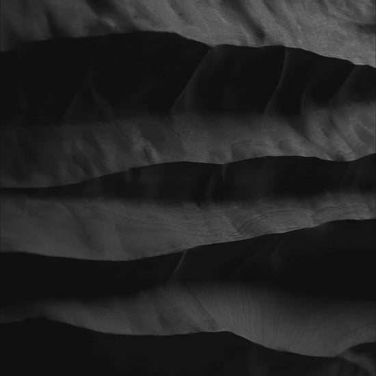 Video of Mountain Echo Black showing the depth and shifting shadows of its carved black wood relief