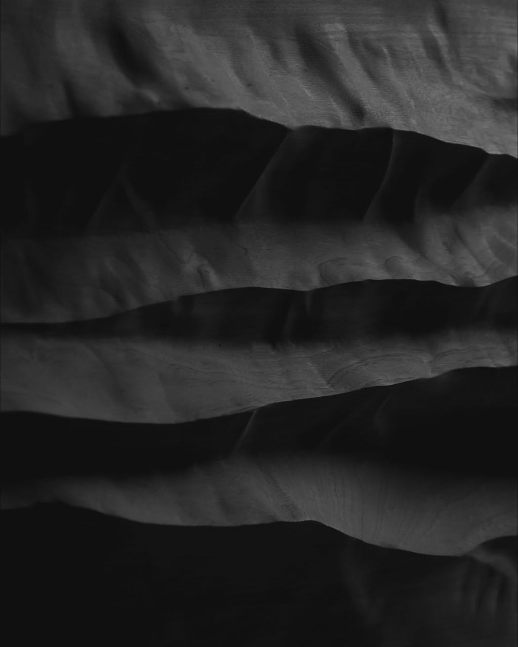 Video of Mountain Echo Black showing the depth and shifting shadows of its carved black wood relief