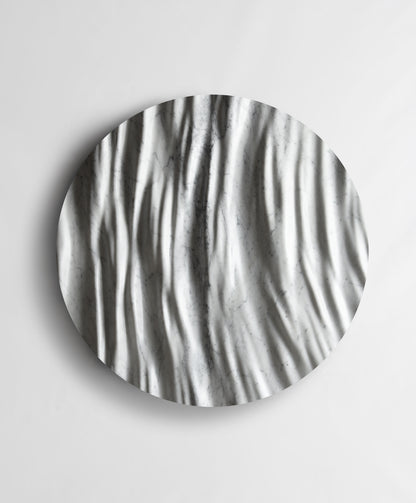 Round Eternal Carrara marble wall sculpture front view with flowing vertical folds and natural grey veining