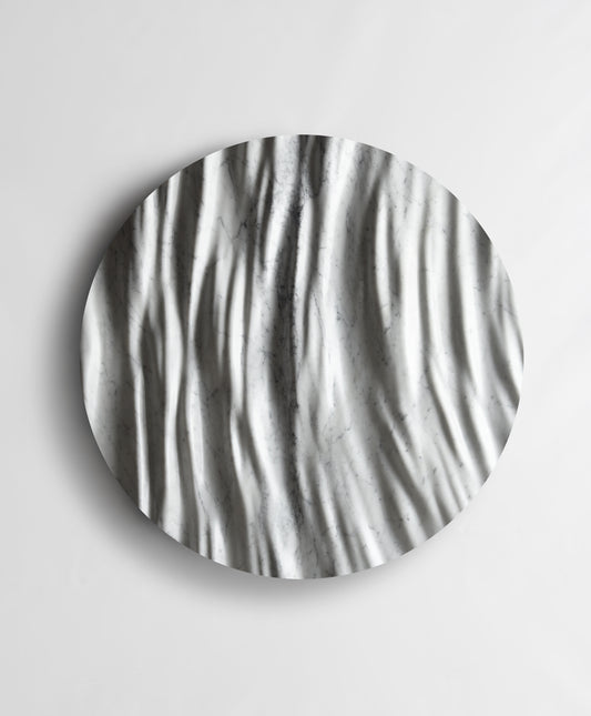 Round Eternal Carrara marble wall sculpture front view with flowing vertical folds and natural grey veining