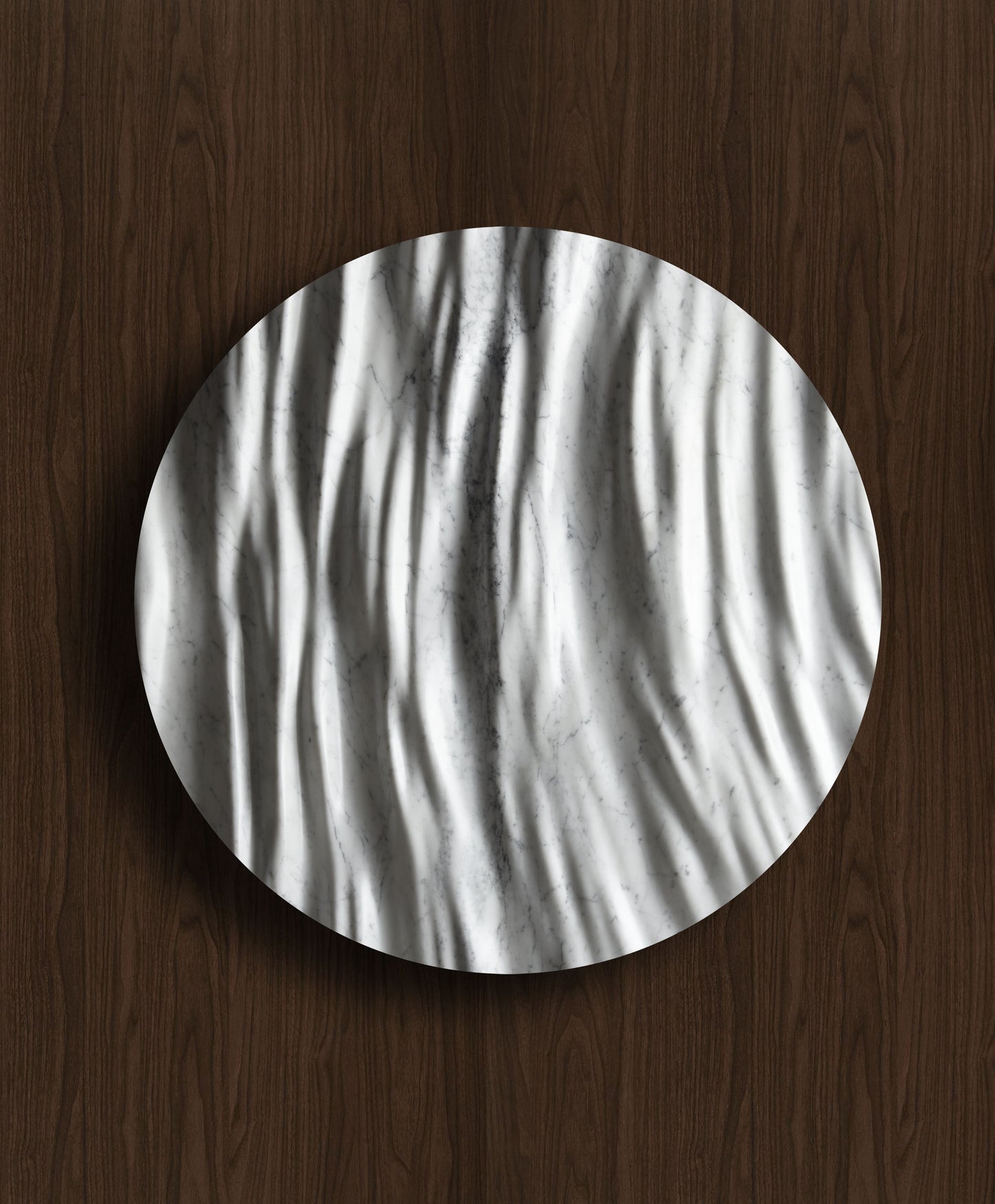 Round Eternal Carrara marble wall sculpture displayed on a warm walnut background with sculpted folds and natural veining