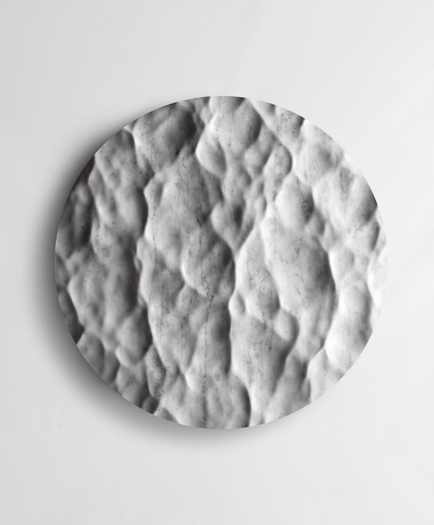 Round Liquid Marble Carrara wall sculpture front view with fluid carved relief and natural grey veining