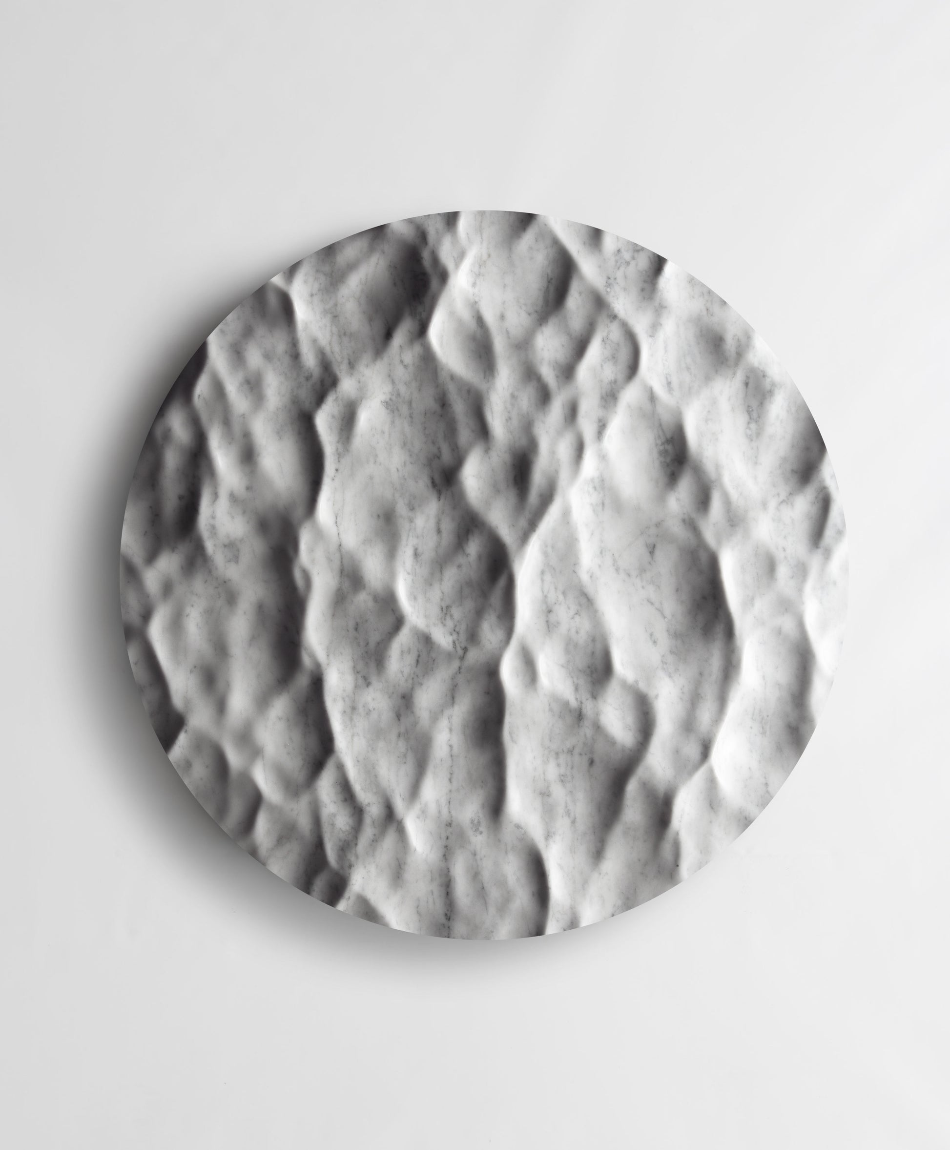 Round Liquid Marble Carrara wall sculpture front view with fluid carved relief and natural grey veining