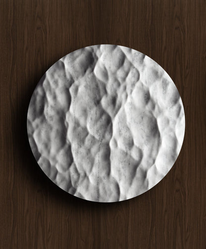 Round Liquid Marble Carrara wall sculpture displayed on a warm walnut background with fluid relief and natural veining