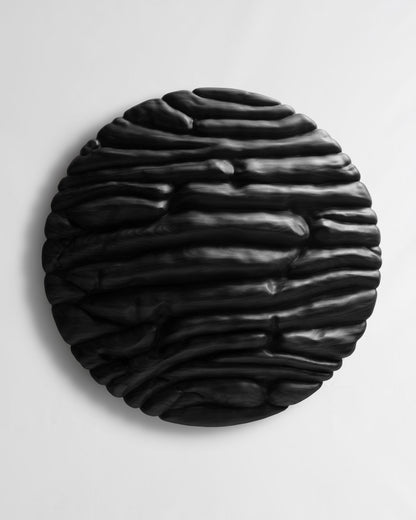 Front view of Strata Black, a round wood wall sculpture with deep layered organic relief