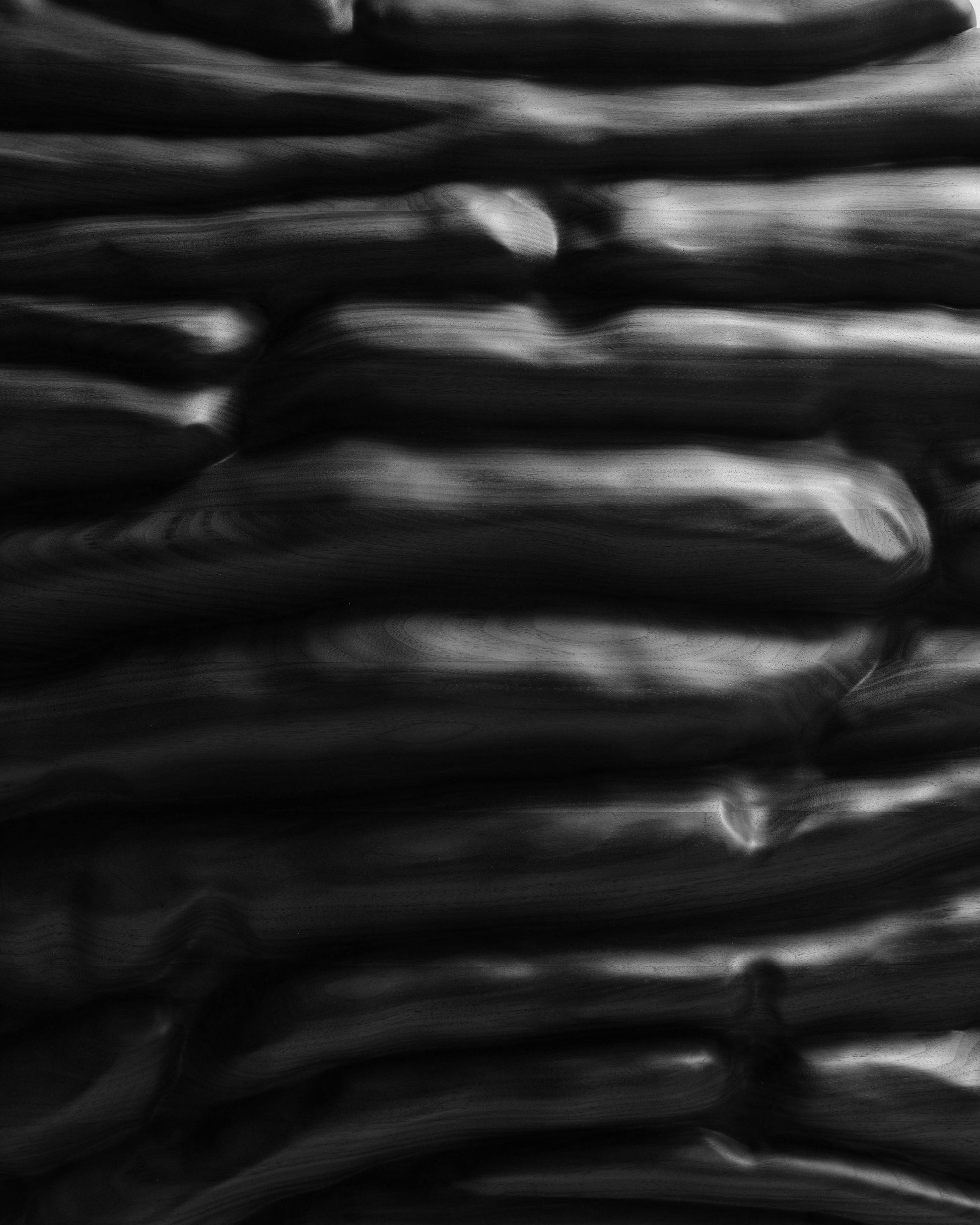 Close detail of Strata Black showing horizontal sculpted layers and deep recesses