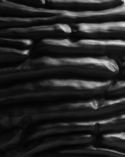 Close detail of Strata Black showing horizontal sculpted layers and deep recesses