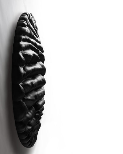 Side profile of Strata Black revealing the depth of its projecting black wood relief