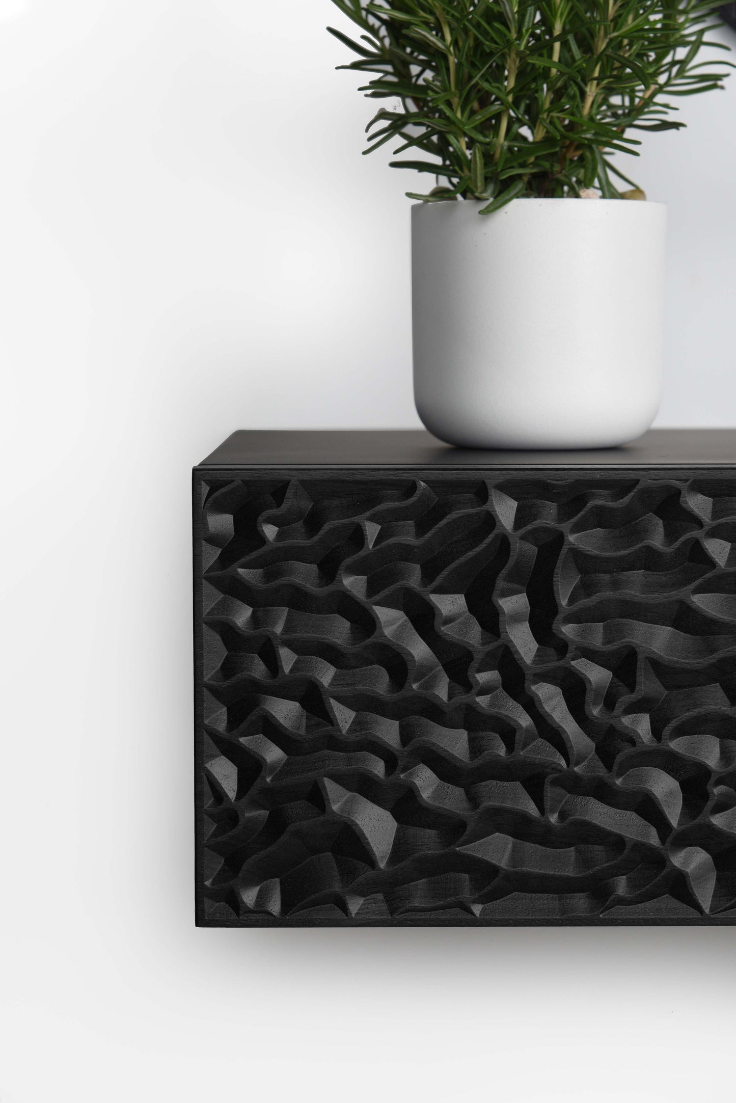 Front close up of the total black console showing depth and clean edge finishing