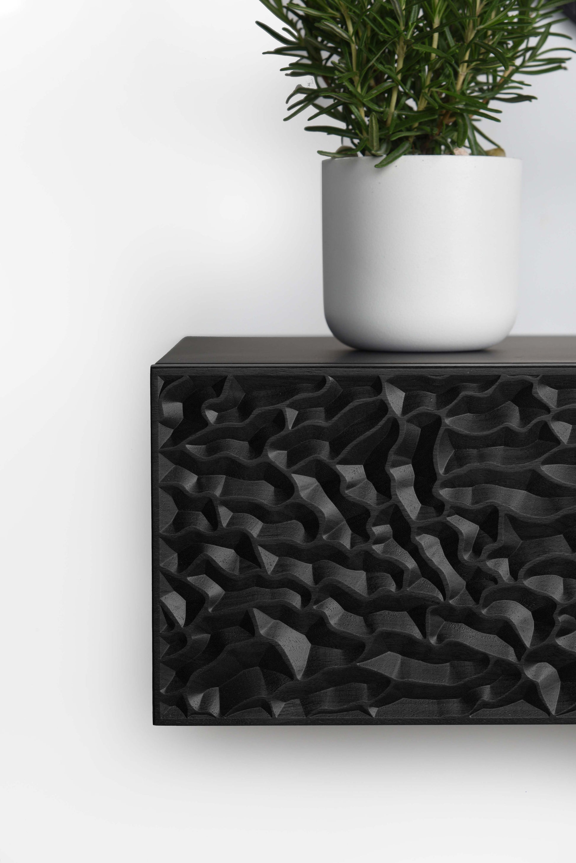 Front close up of the total black console showing depth and clean edge finishing