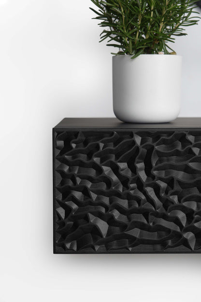 Front close up of the total black console showing depth and clean edge finishing