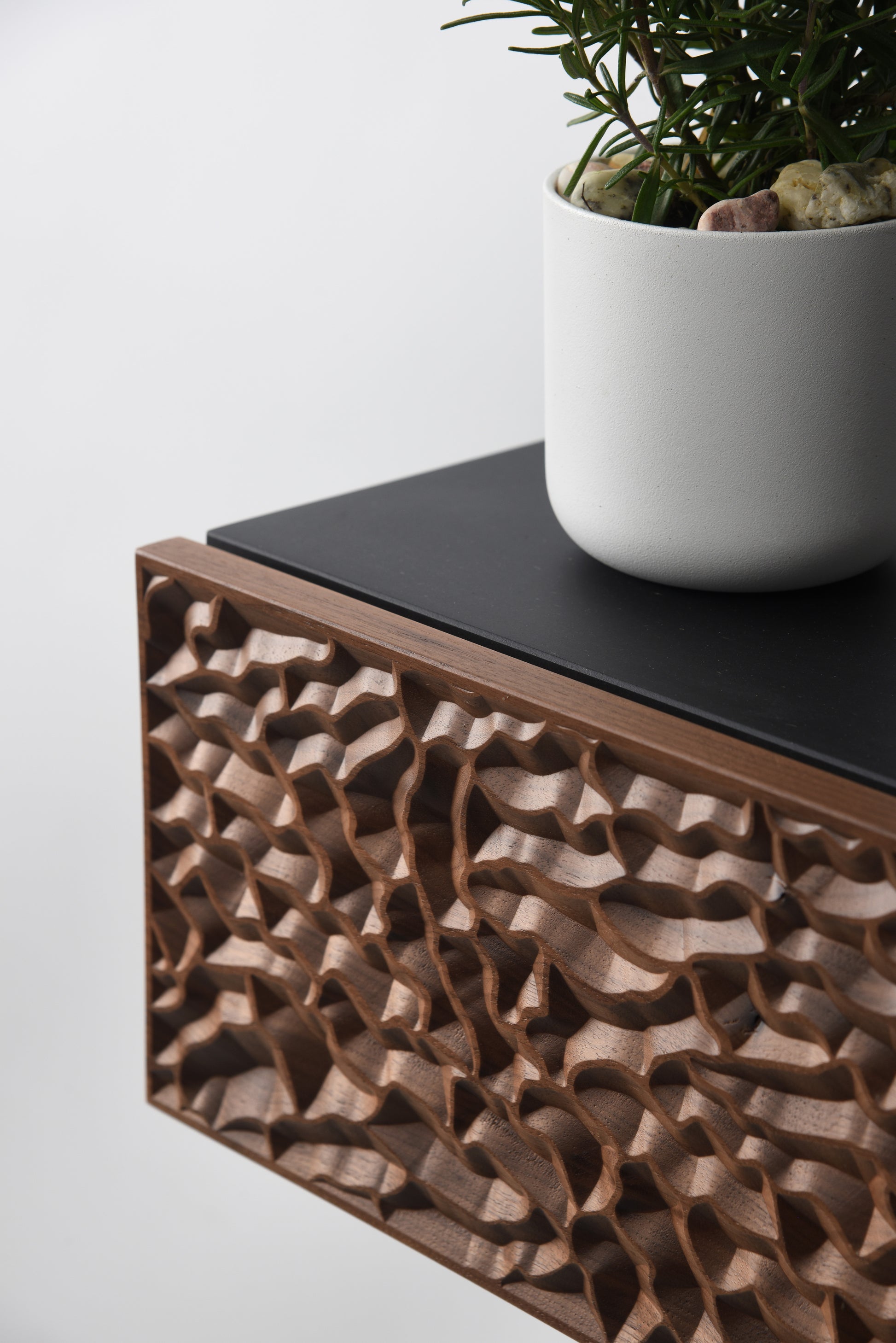 Front close up of the walnut carved drawer front showing grain and relief depth