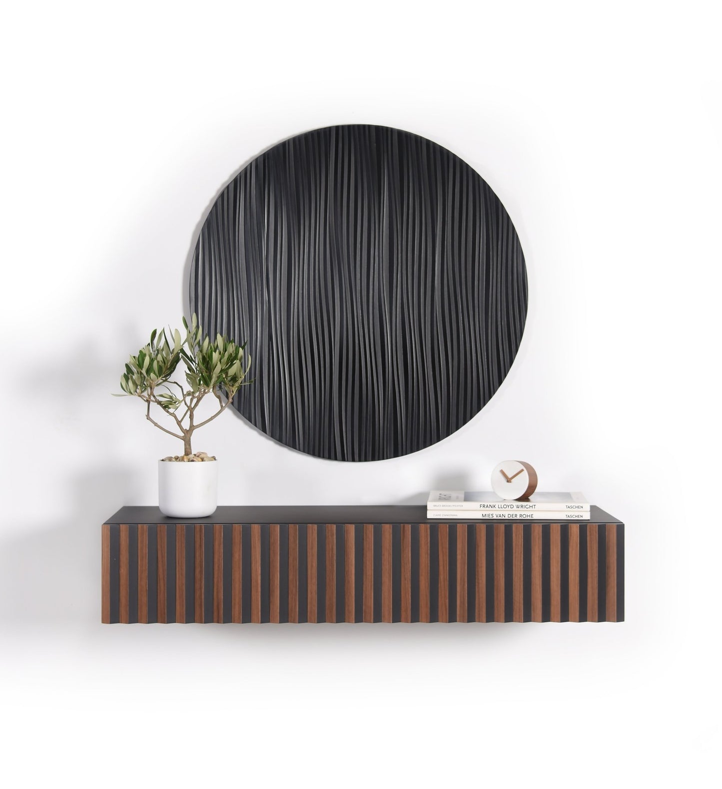 Suspended walnut and black floating console with a round black wall sculpture installed above