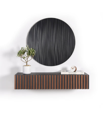 Suspended walnut and black floating console with a round black wall sculpture installed above