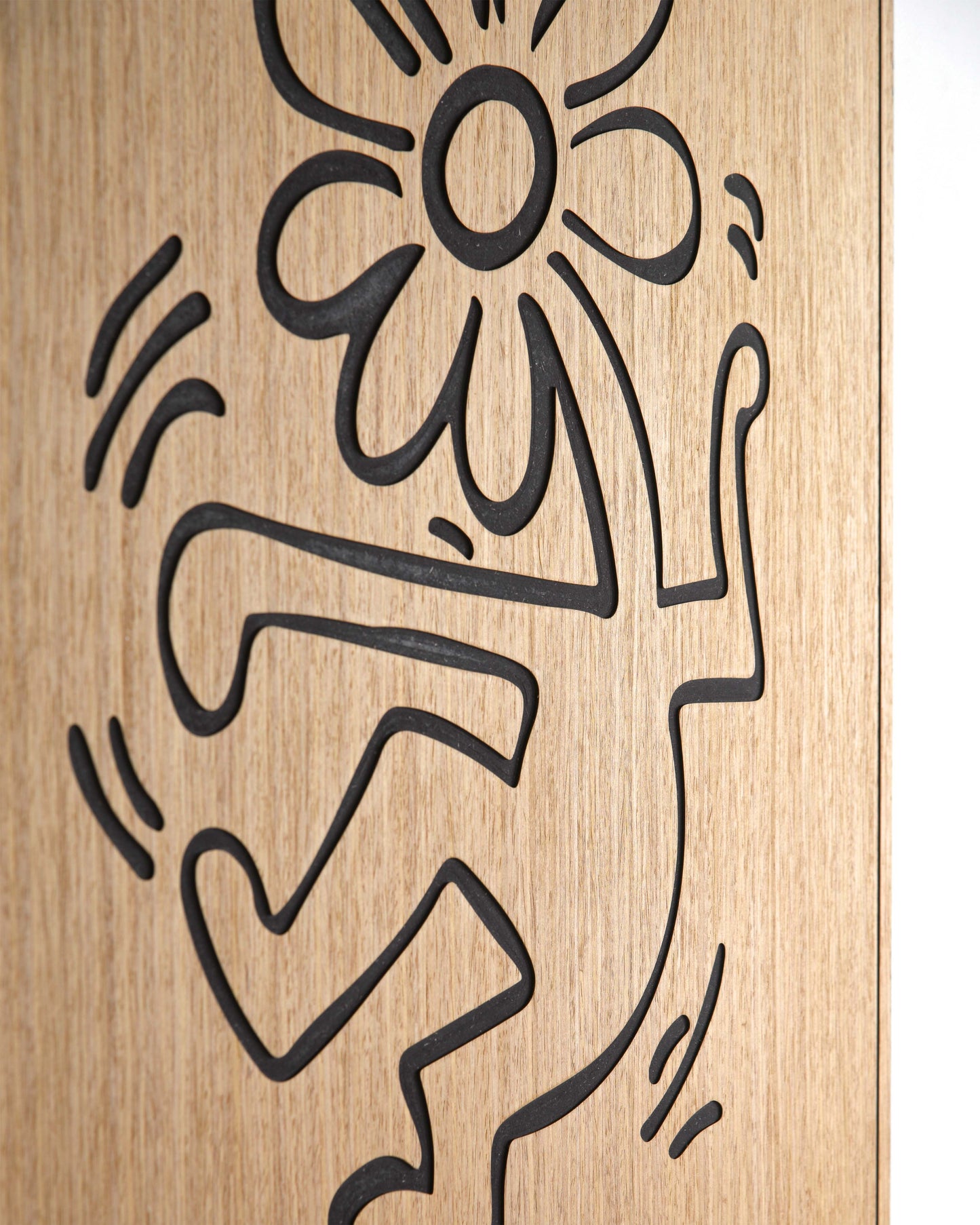 Close up of the flower carving and black relief lines on oak wood
