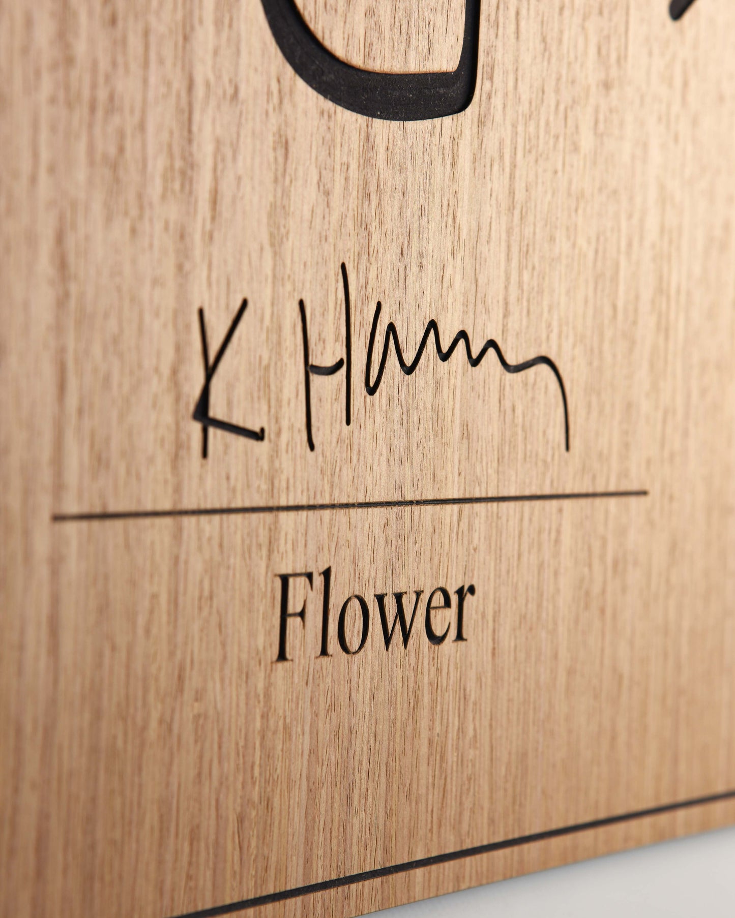 Detail of Keith Haring signature and Flower title engraved on oak panel