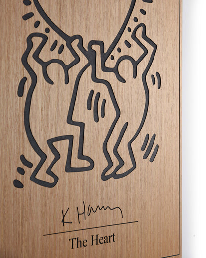 Angled detail of oak grain and black relief on The Heart Keith Haring panel