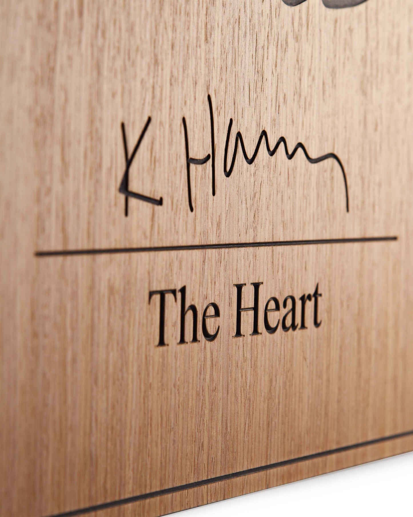 Edge detail of matte finish and carved transition between oak and black relief