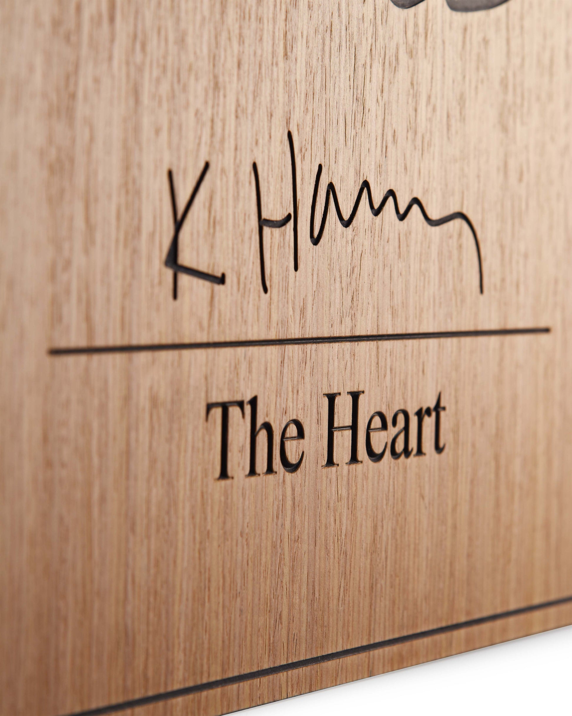Edge detail of matte finish and carved transition between oak and black relief
