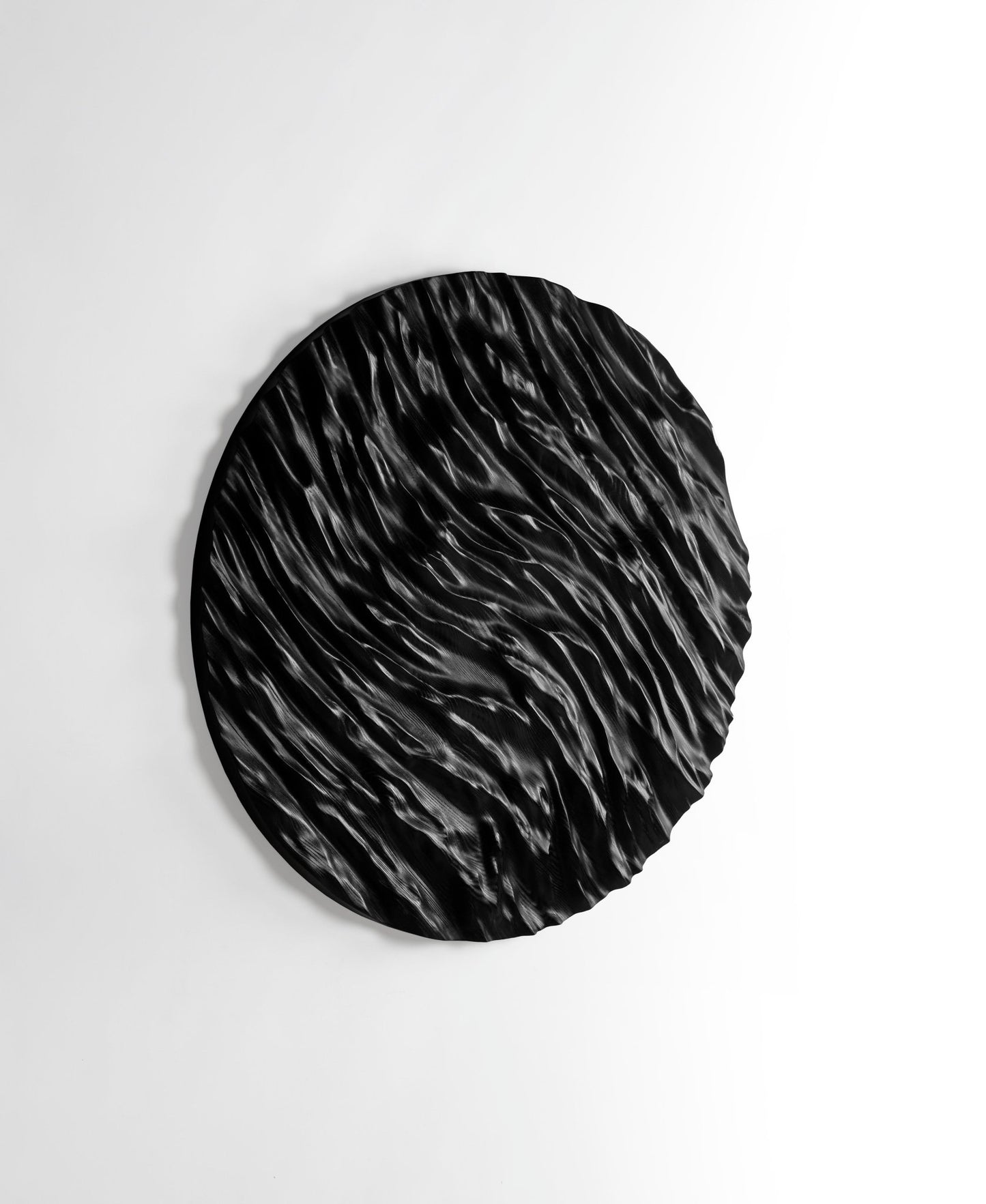 Tight focus on carved ocean ridges in black wood, ideal for new home gift ideas and refined interior decoration aesthetics