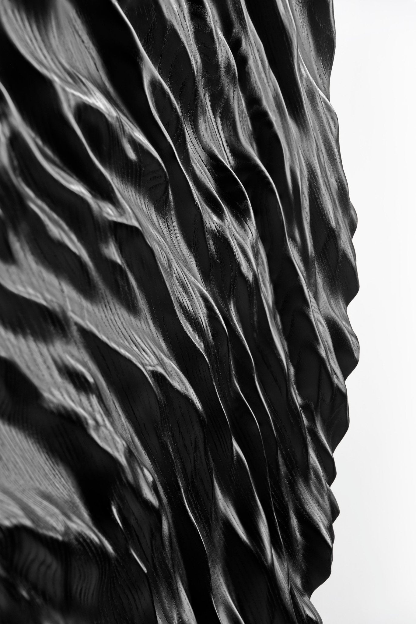Smooth edge highlighting the black wood’s subdued grain, merging boho chic interior appeal with a crisp geometric design motif.