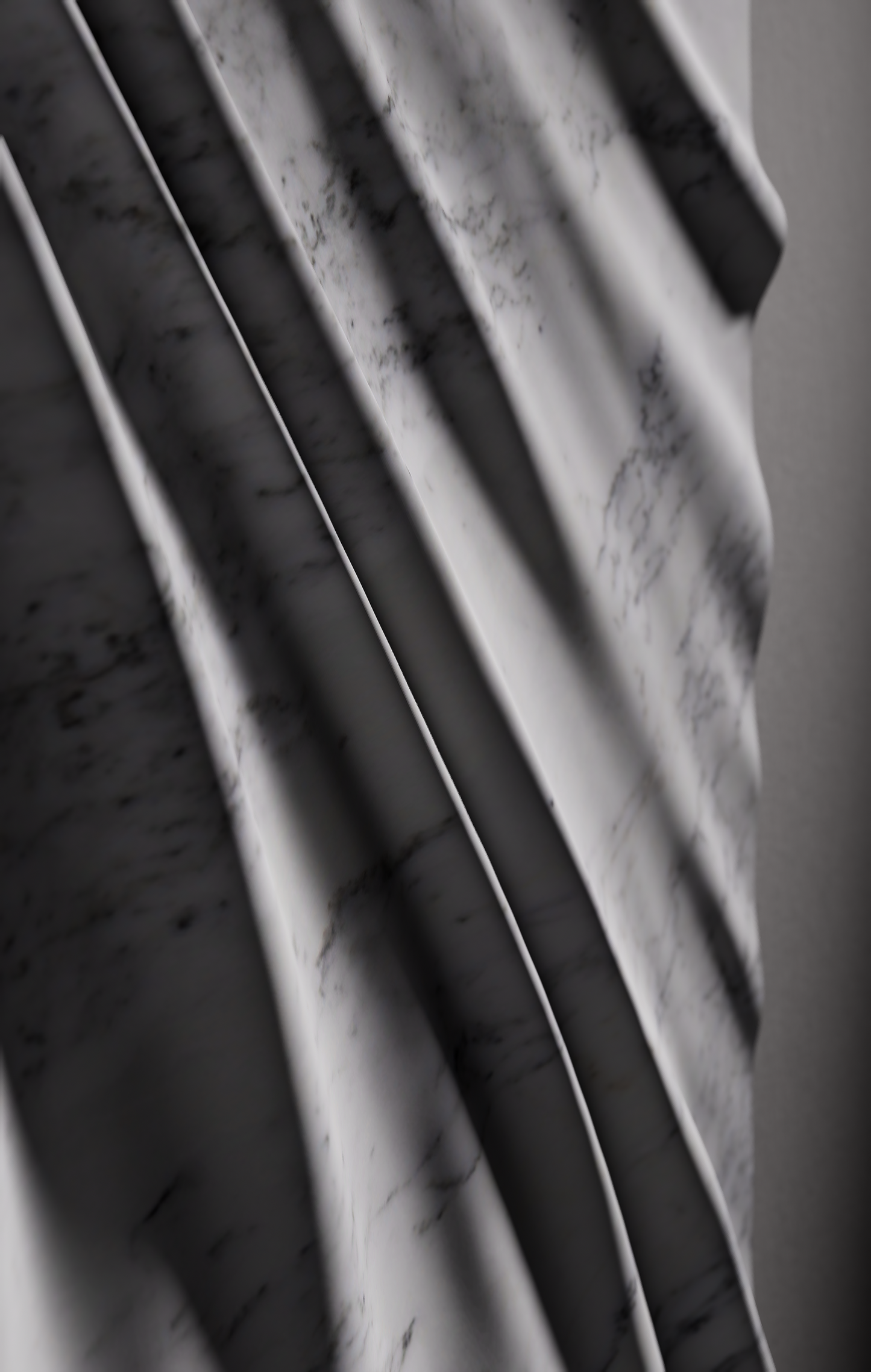 Macro view of draped folds carved in Carrara marble with subtle natural veining
