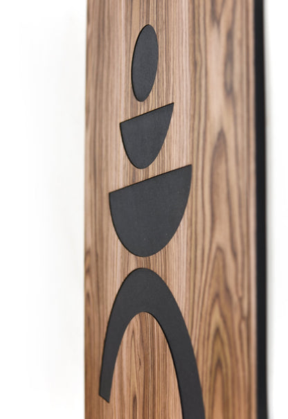 Angled close up of walnut panel showing relief depth and black shapes