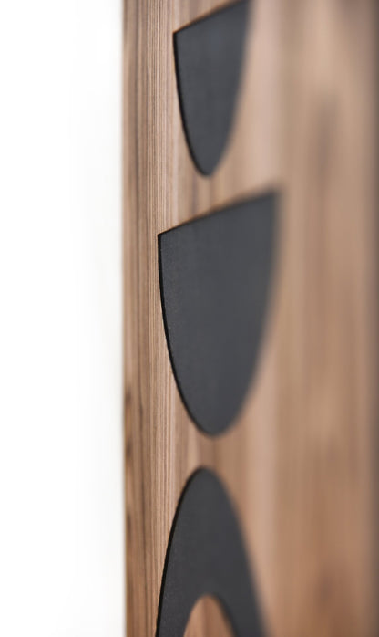 Side close up showing thickness and relief depth of black elements on walnut