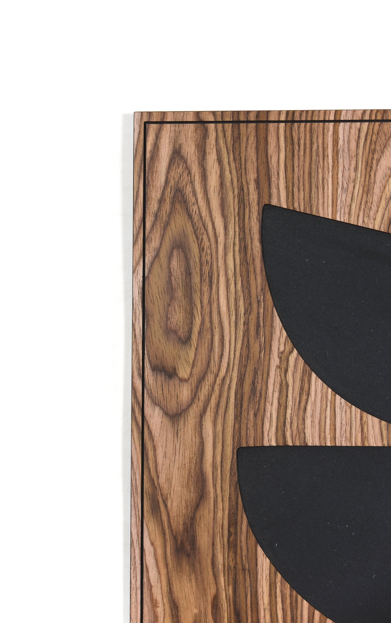 Macro crop of walnut grain and black shape edge, corner detail