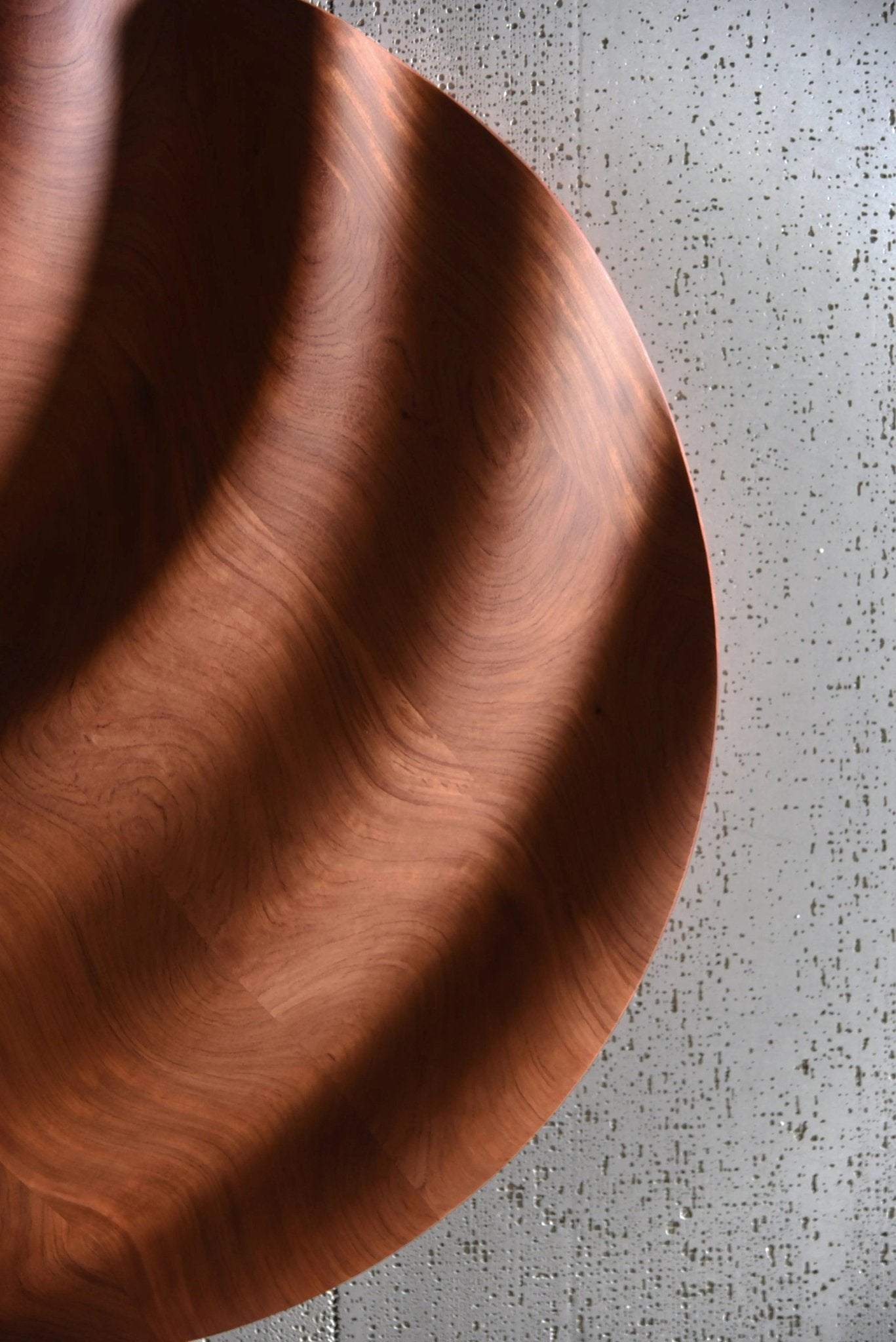 Tight shot focusing on deep wave cuts across bubinga’s surface, adding wood accent wall intrigue and tasteful bathroom design refinement.