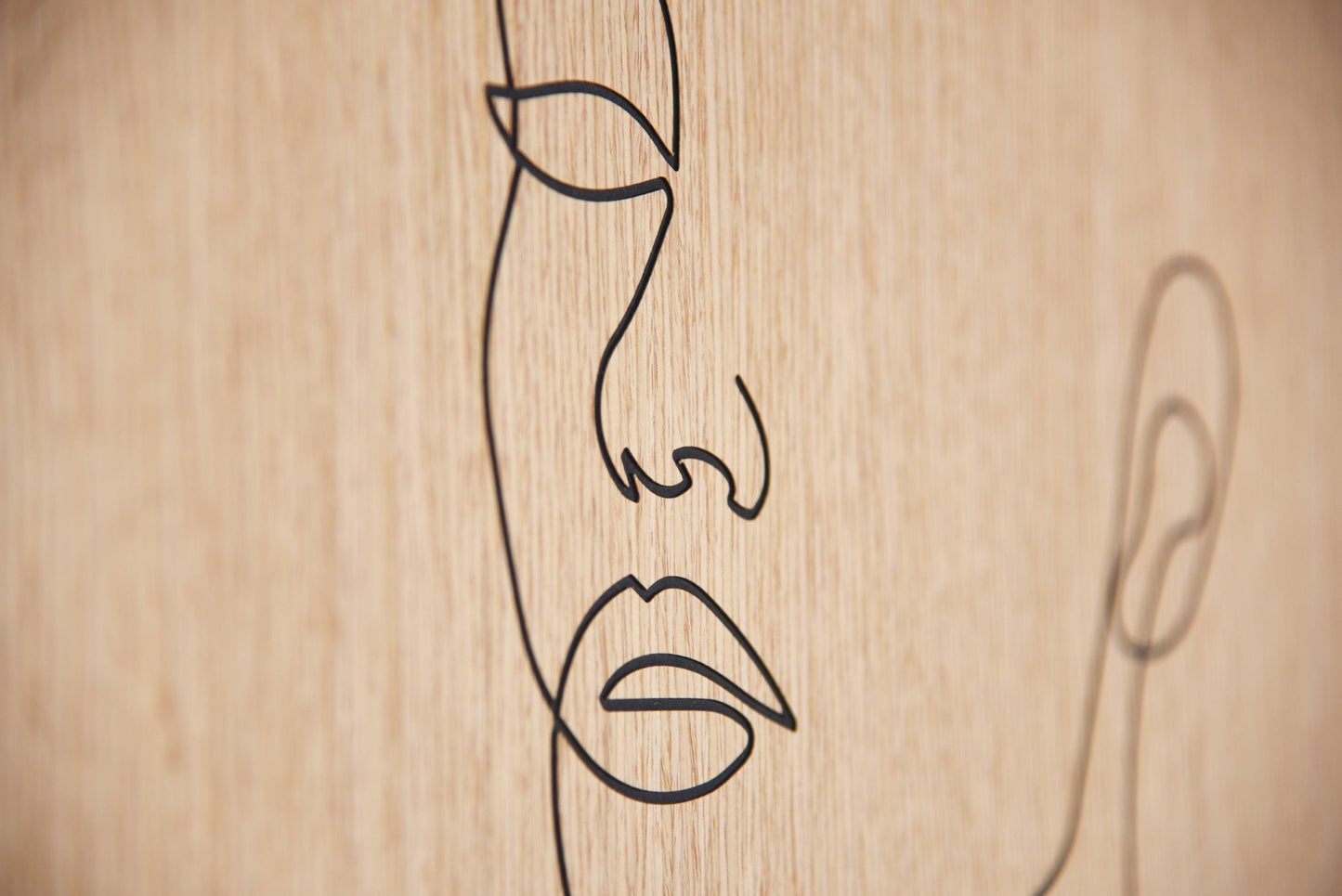 Macro detail of the carved lips and nose line on oak