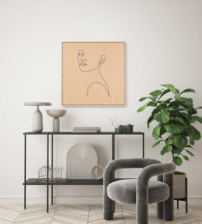 Carved oak wall art with a minimal line portrait, styled above a console table