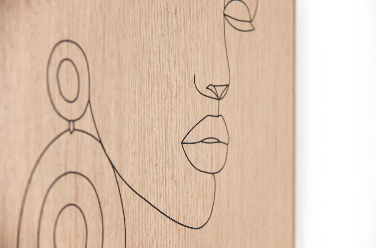 Corner detail of the oak panel showing the fine carved line and clean edge finish