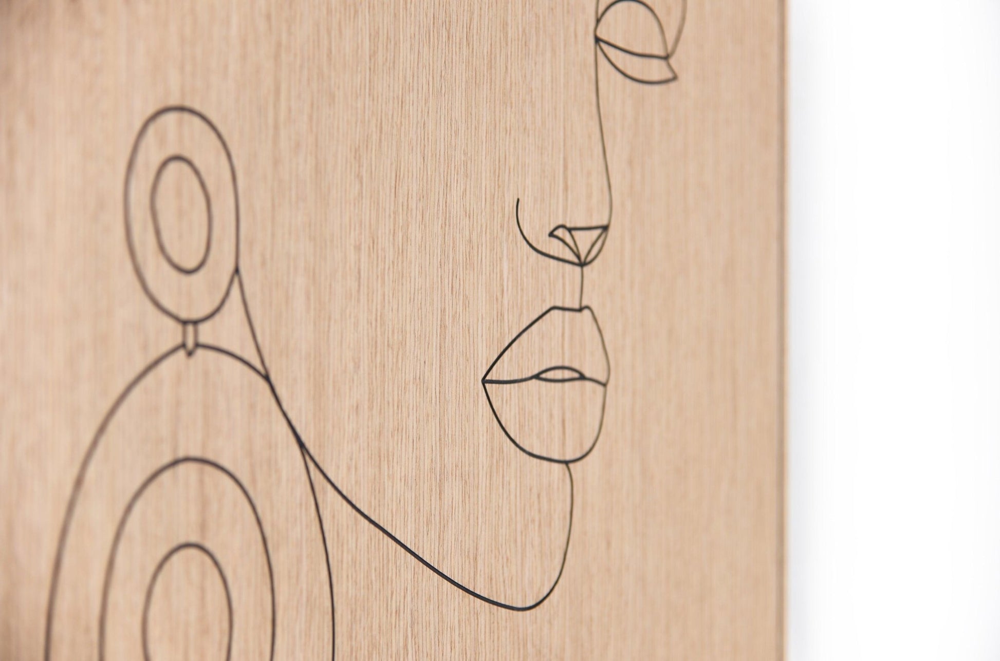 Corner detail of the oak panel showing the fine carved line and clean edge finish