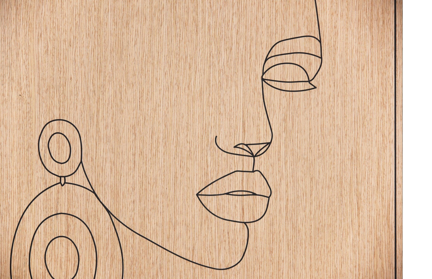 Close up of the carved line portrait on oak showing the earring and facial profile detail