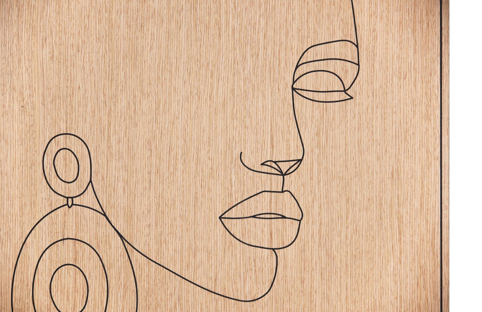 Close up of the carved line portrait on oak showing the earring and facial profile detail