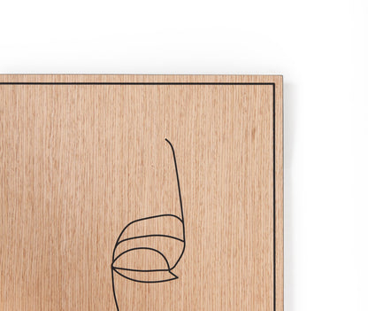 Minimal carved portrait on oak, Woman with Earring wall art styled in a warm living room
